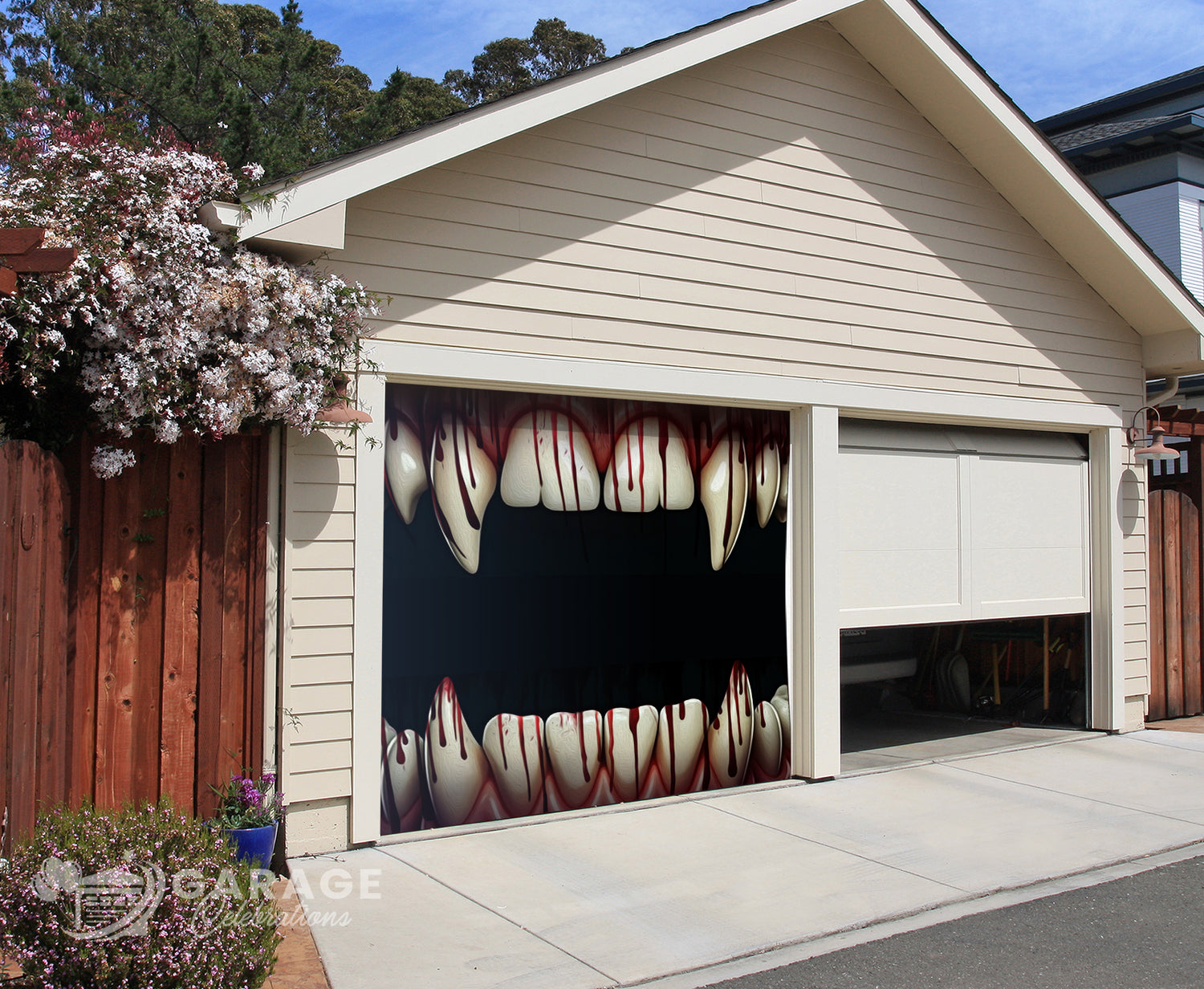 A garage door decorated with a Halloween-themed mouth design, featuring sharp fangs and blood-stained appearance.