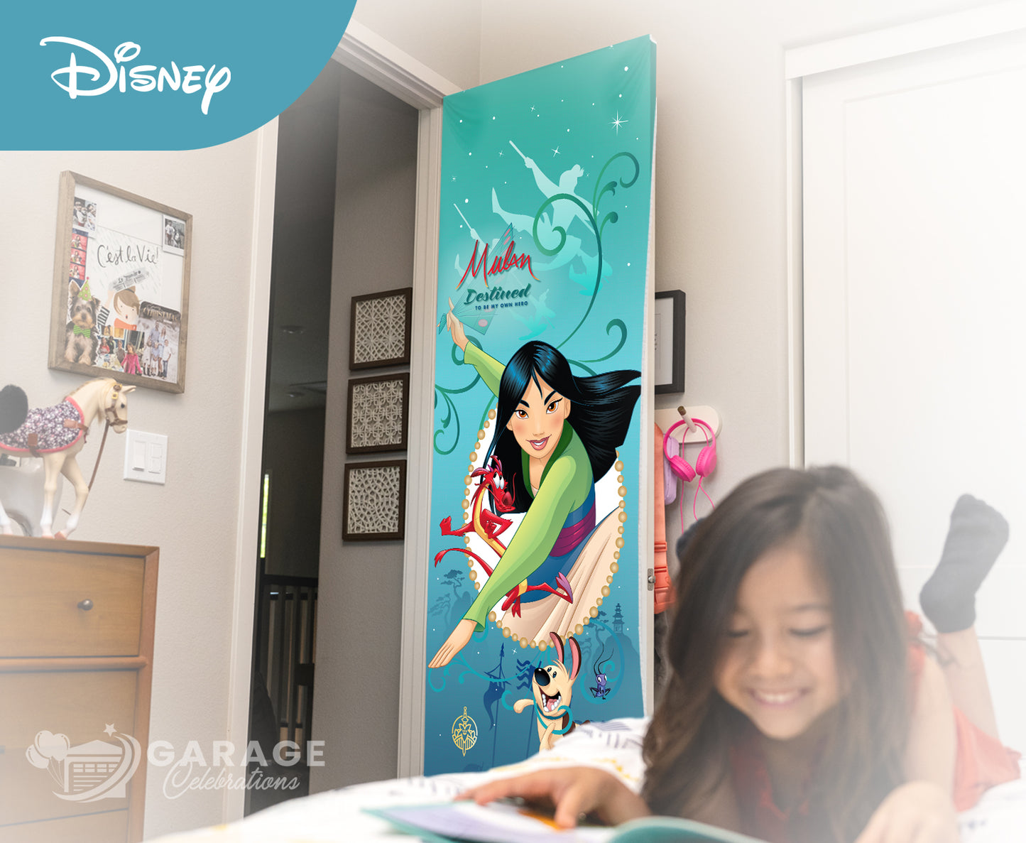 Girl reading a book in front of a Disney Mulan door poster in a bedroom.