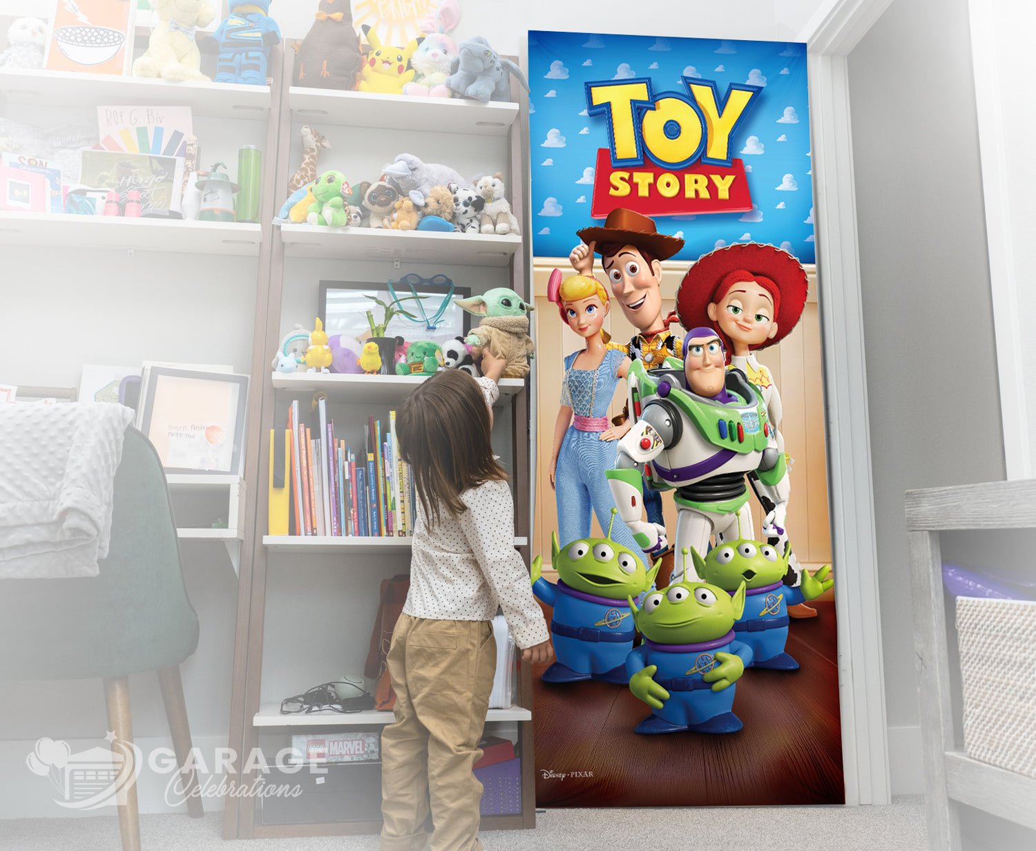 Child standing in front of a 'Toy Story' themed door decoration in a room with shelves and toys.