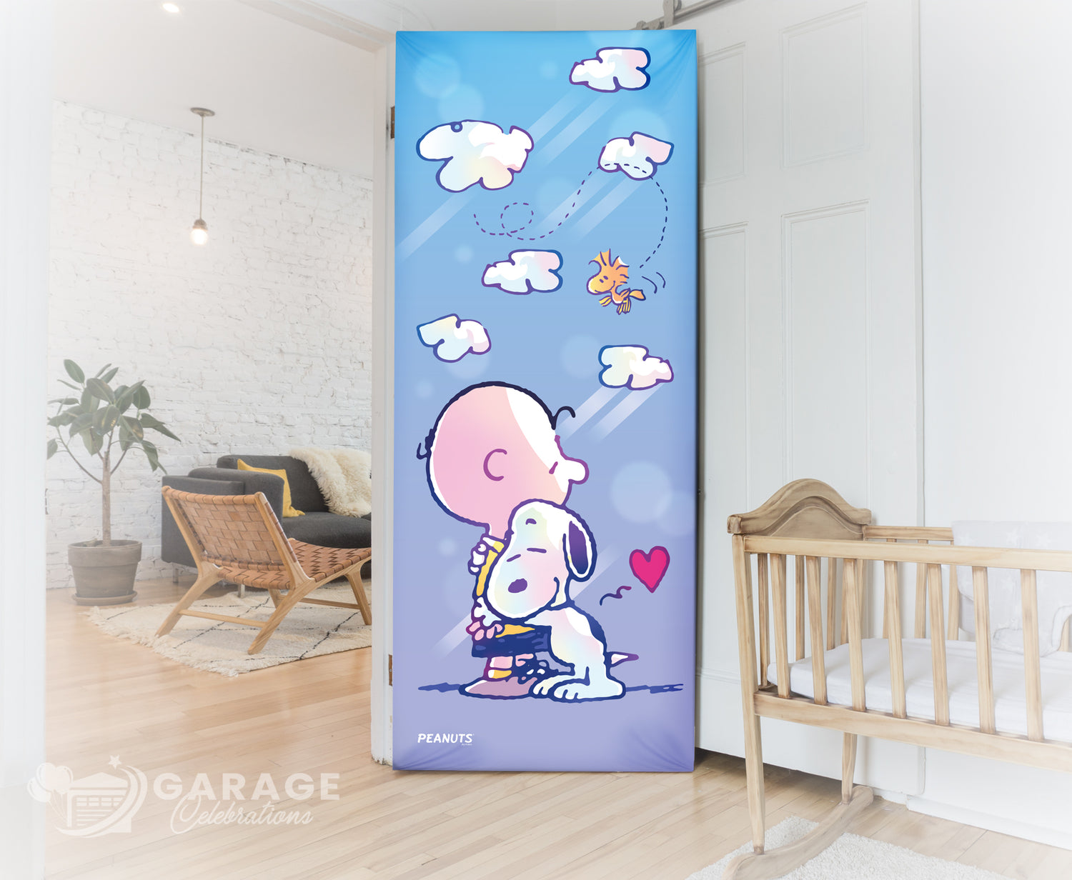 Decorative garage door with cartoon characters in a room with a crib and plant.